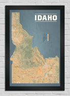 Framed map of Idaho on a white brick wall background