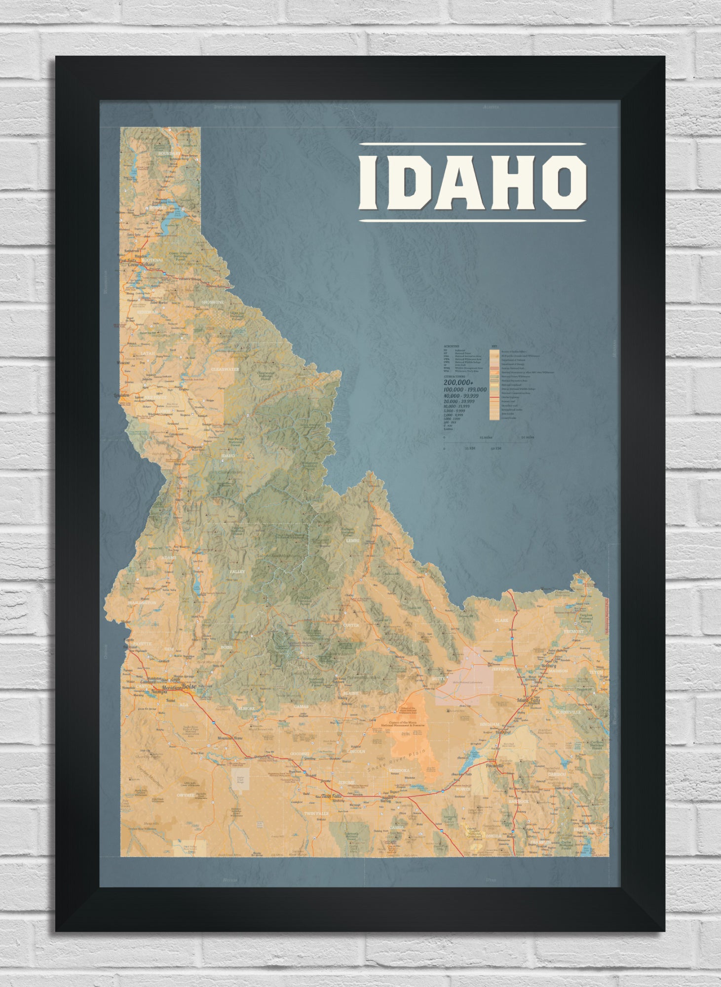 Framed map of Idaho on a white brick wall background