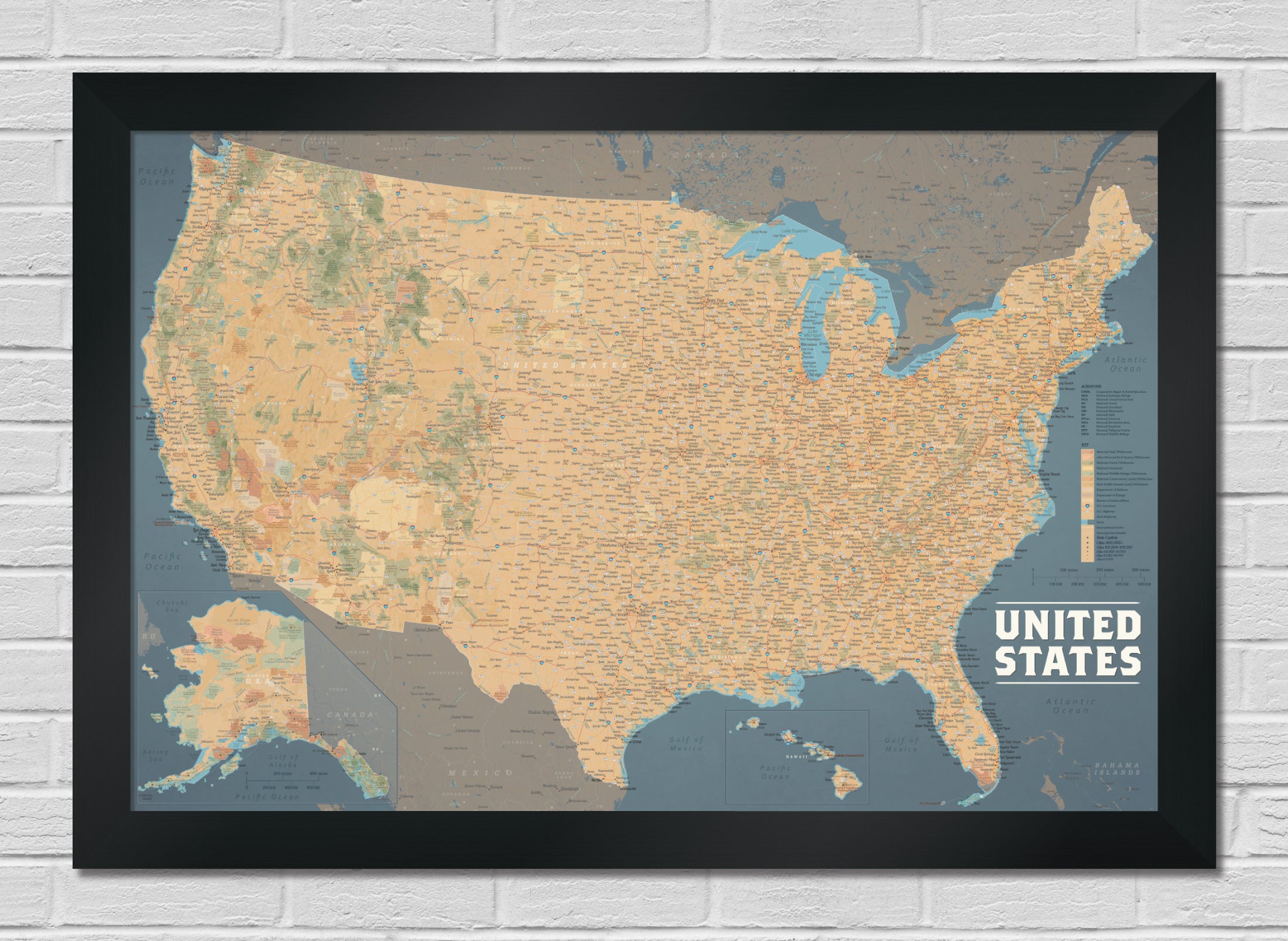 Framed map of the United States on a white brick wall - 2" brushed black frame shown